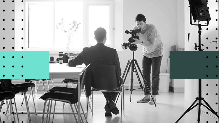 A man sitting in an office in front of a camera