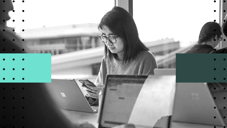 A woman in an office working in front of her laptop