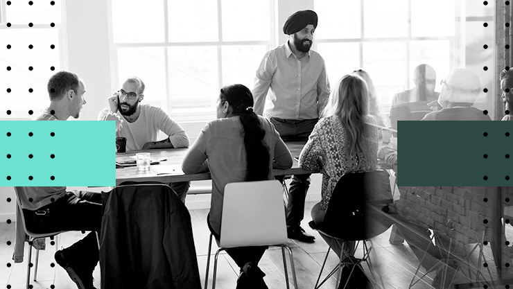 A group of people having a discussion in a conference room.