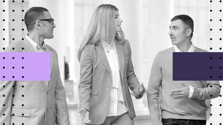 A group of people having a discussion while walking
