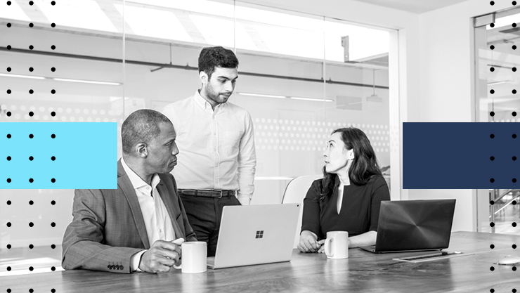 A group of people having a discussion in front of their laptops