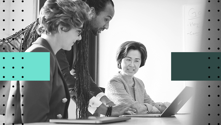 A group of colleagues looking at a laptop screen