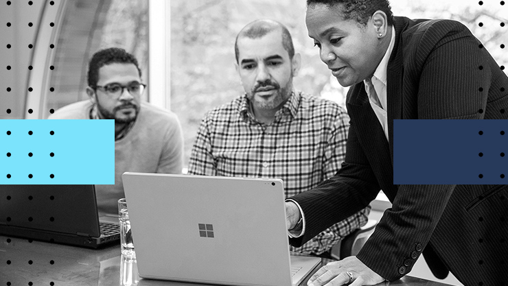 A group of colleagues looking at a laptop screen