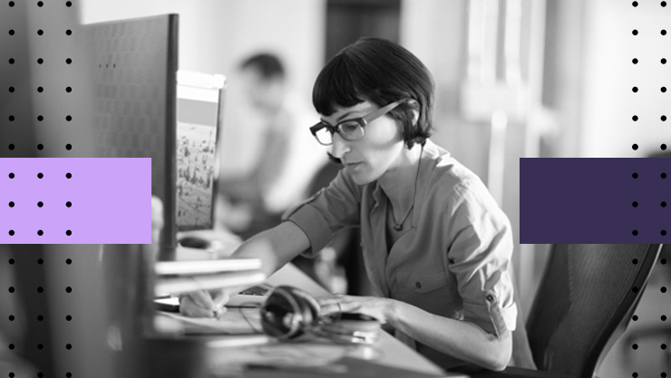 Woman working at a computer monitor in an office