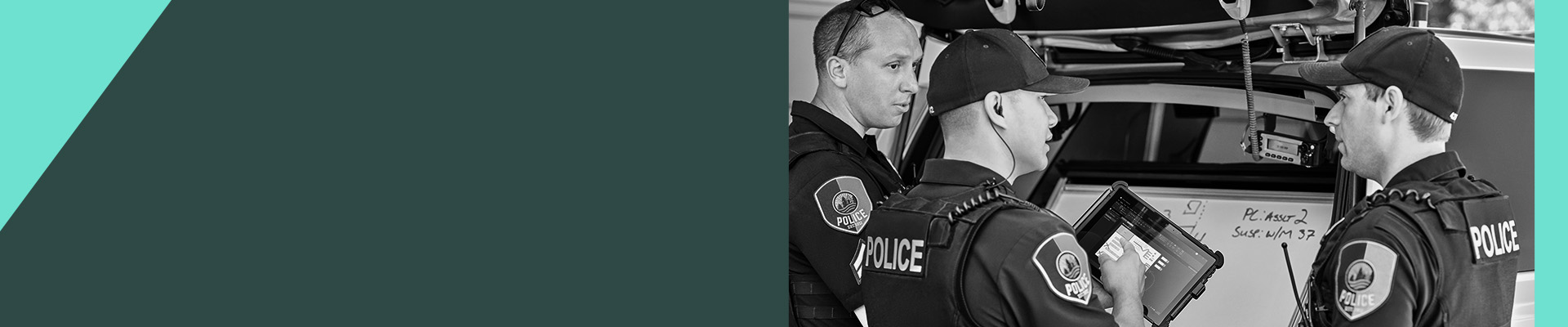 Three police officers looking at a tablet